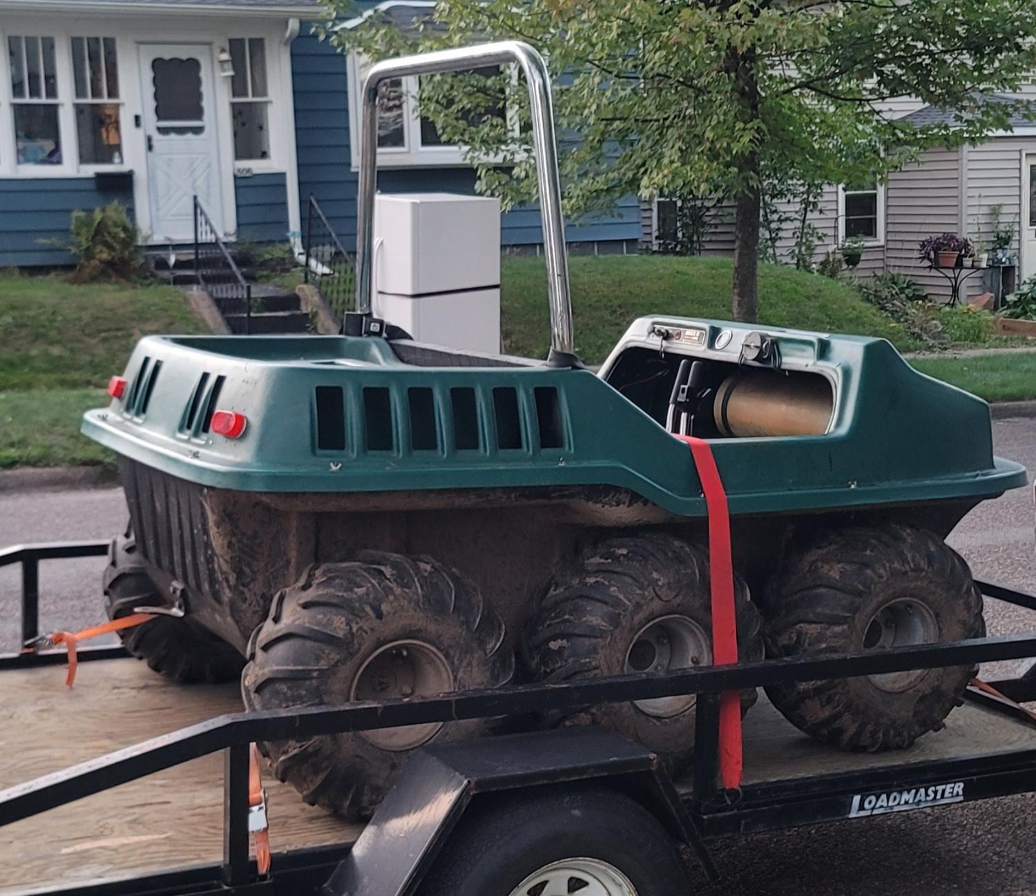 A six-wheel Argo amphibious ATV strapped on a trailer, headed to S & M Small Engine Repair.